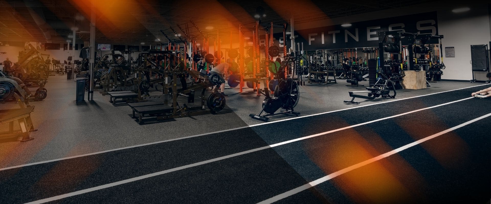 November-2025-best-fitness-join-for-free Wide view of Best Fitness gym featuring strength training racks, weightlifting platforms, and turf lanes for functional workouts