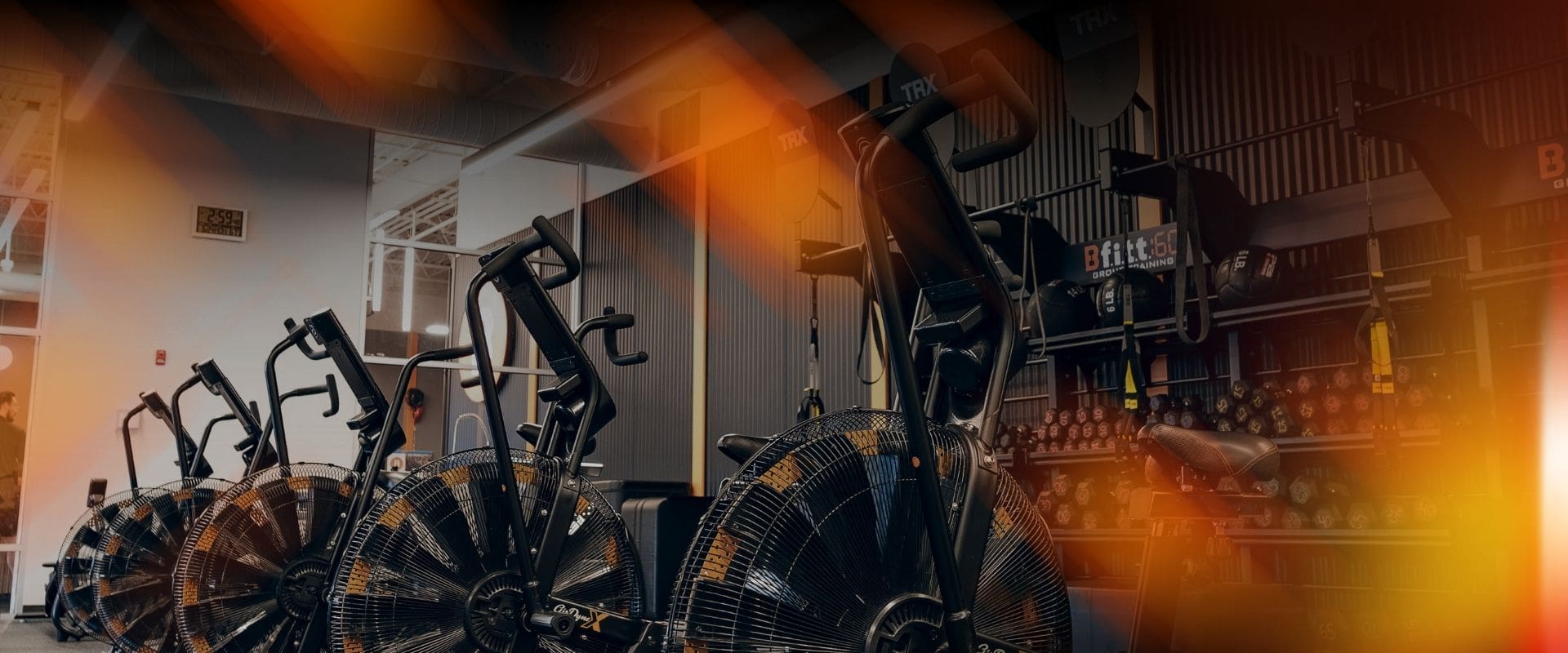 Best Fitness Black Friday 2025 banner featuring $0 to join promotion with bold orange and white text over a gym background with bikes, weights, and training equipment.