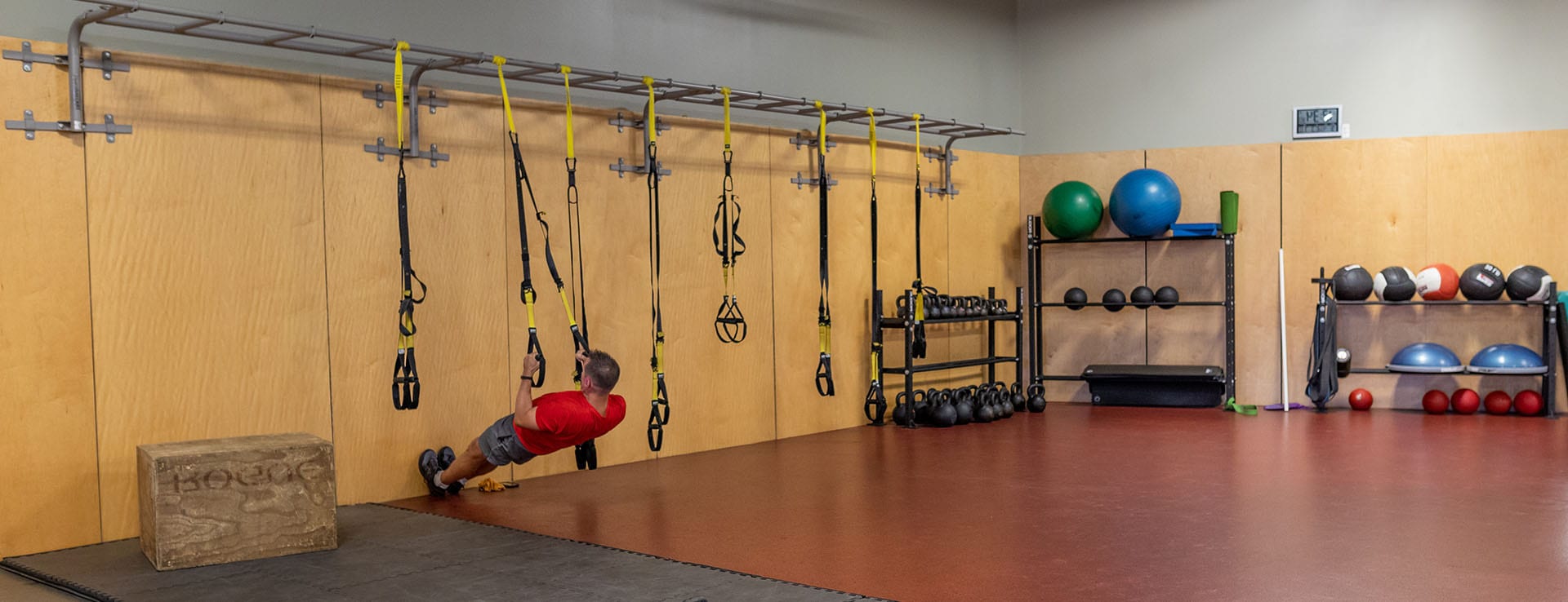 man using functional training area in modern gym area i