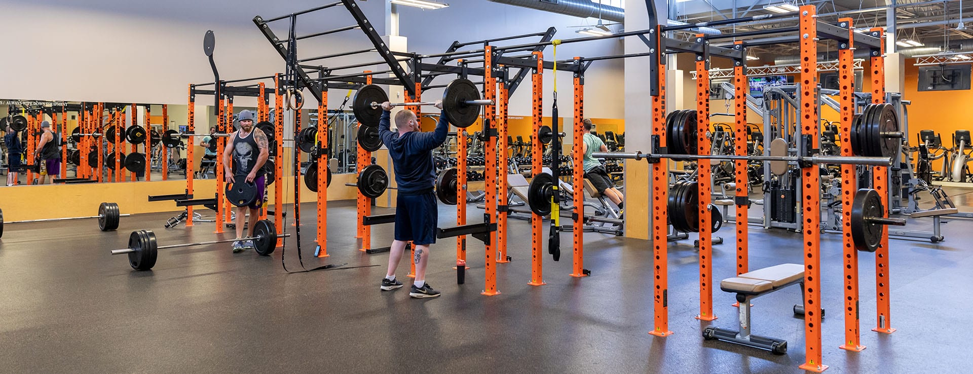 man lifting weights at modern gym in albany
