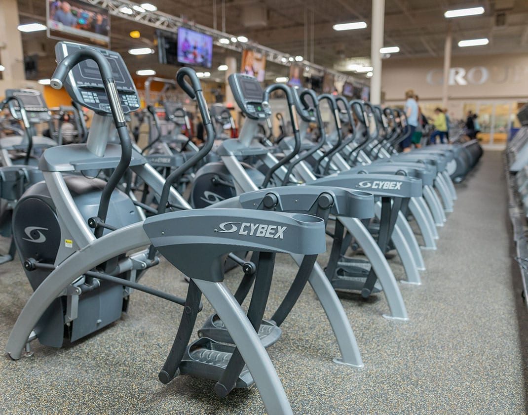 row of cardio equipment in modern gym