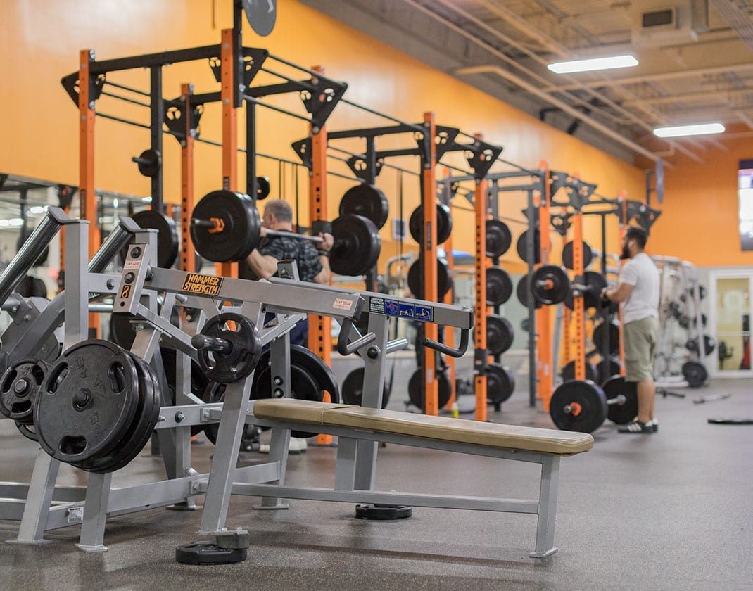 strength training exercise machines inside spacious gym