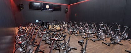 cycle studio at modern fitness studio with exercise equipment