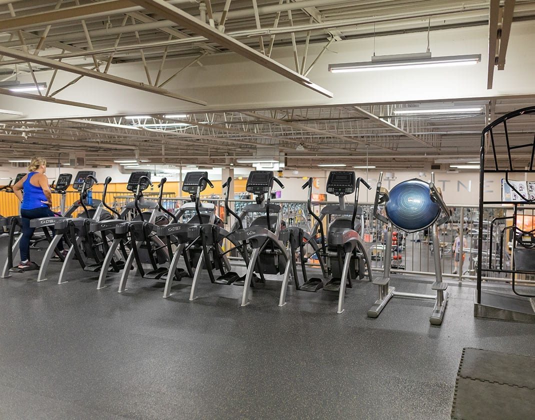 row of exercise equipment in modern gym