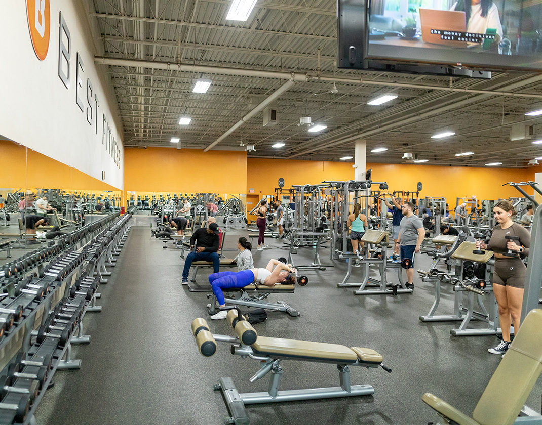 gym members using free weights in a modern gym