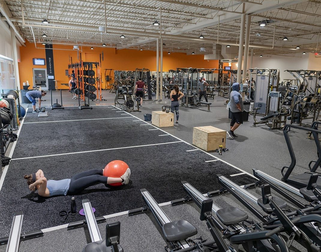 woman laying down and working out on spacious circuit training floor
