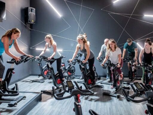 a group fitness class in a spinning studio at a danvers gym
