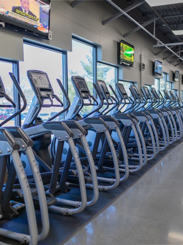 a row of elliptical cardio training machines at a gym near me