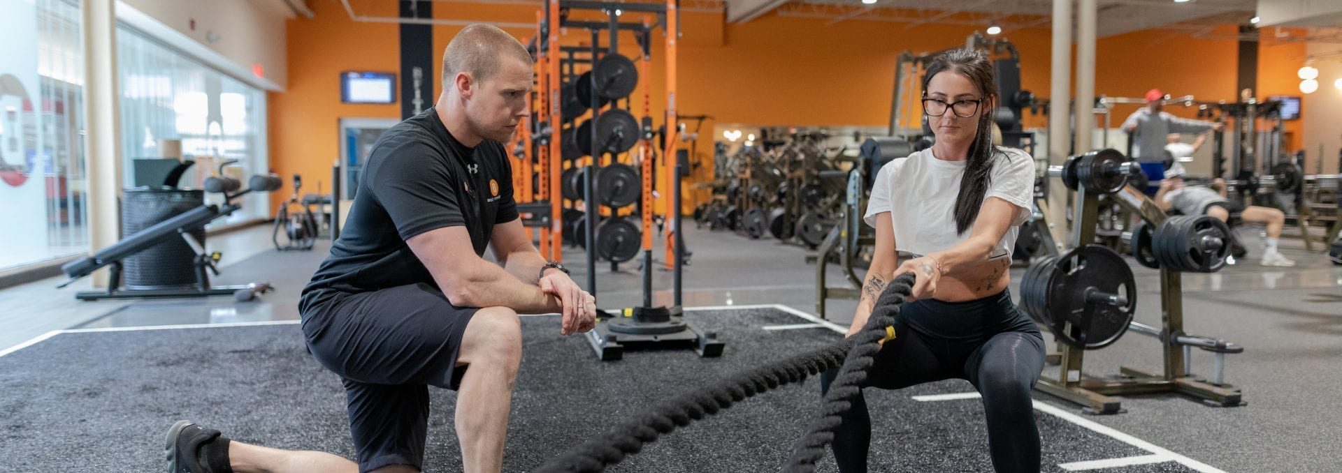 woman working out with personal trainer in gym