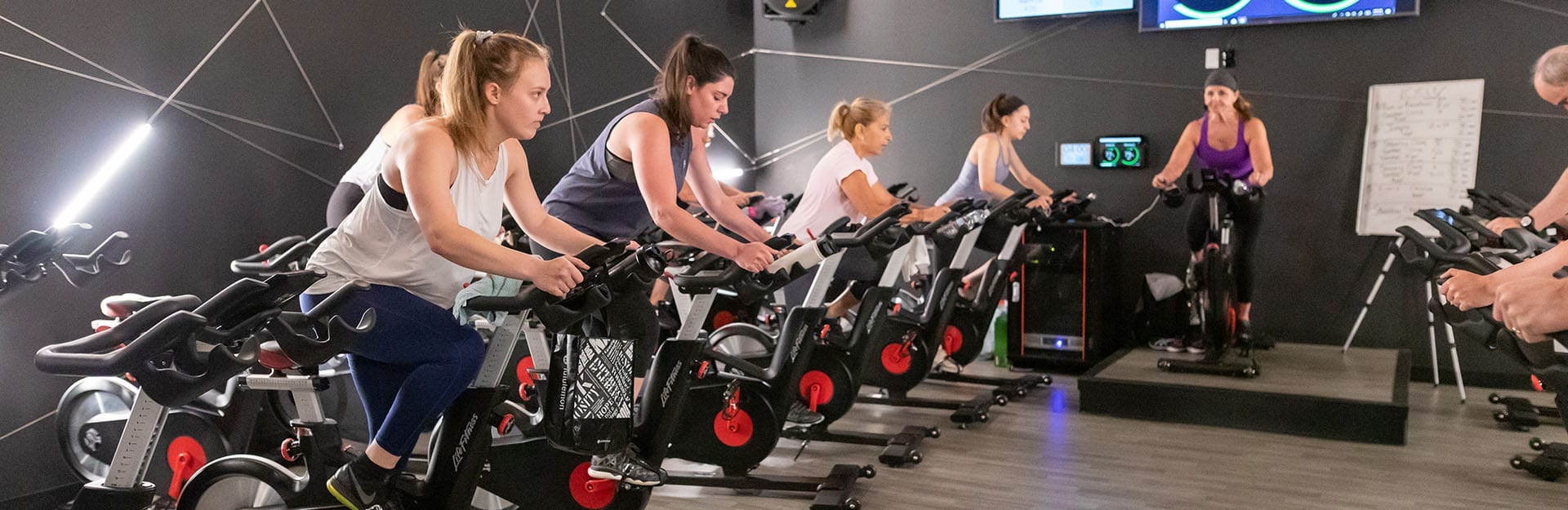 cycling class in session at modern gym