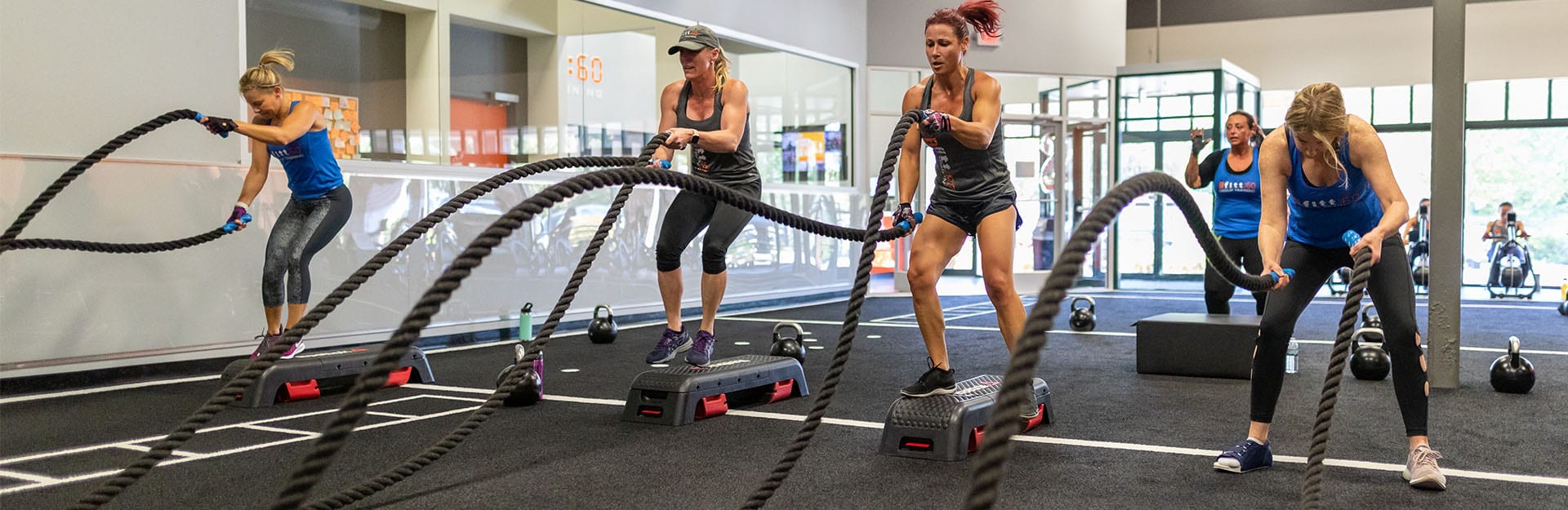 women using combat ropes in workout
