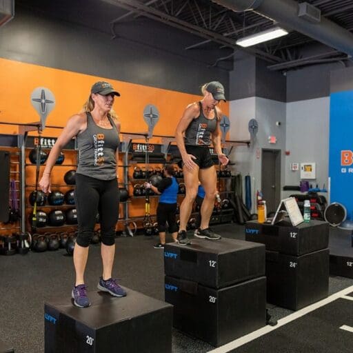gym members do box jumps during a bfitt60 group training class at best fitness gym in schenectady new york