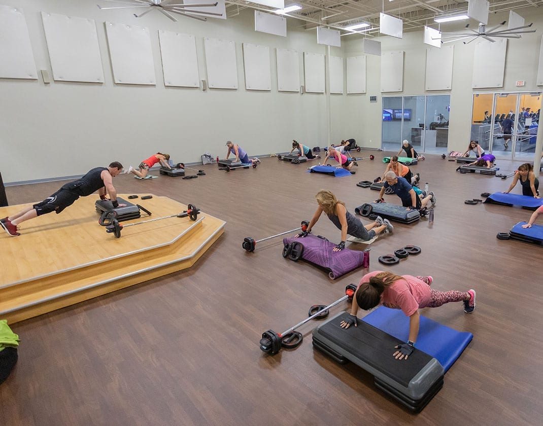 spacious fitness studio with group class in session