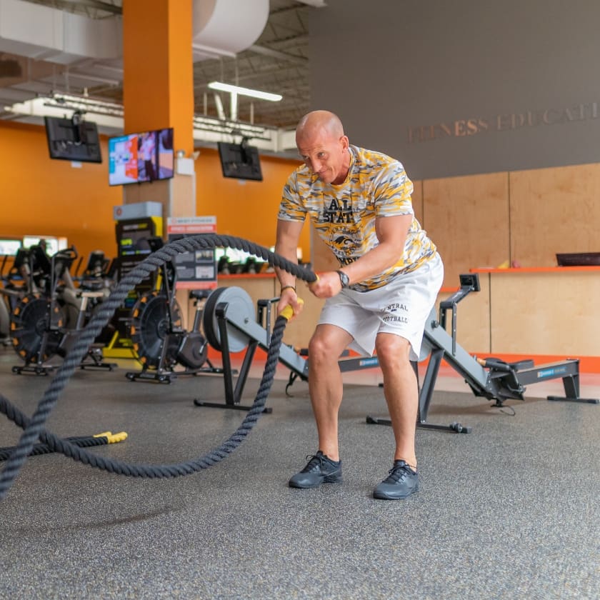 a gym member uses weighted ropes for strength training at a gym near me in springfield ma