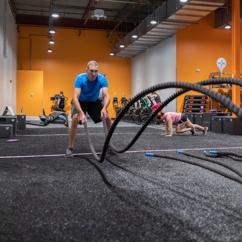 a gym member uses weighted ropes for a fitness training exercise at a gym near me in springfield