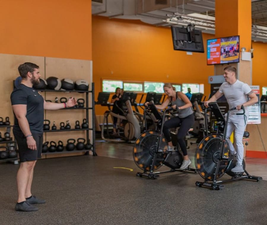 gym members pedal on air bikes during a personal training session at a gym near me in springfield