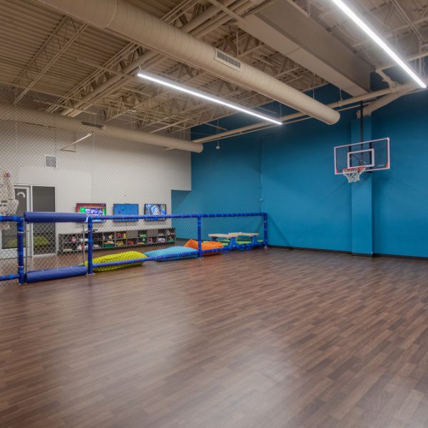 a kids zone with a basketball goal and other fun and safe activities at a woburn best fitness gym