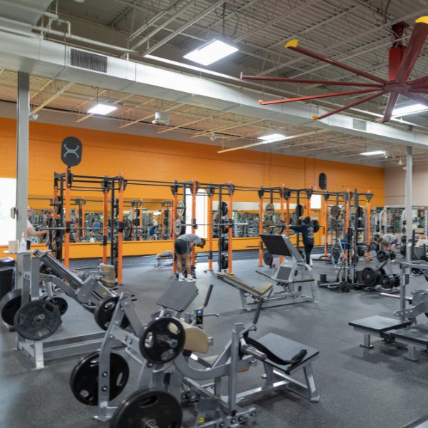 gym members work out in a spacious and clean weight room at a modern woburn gym