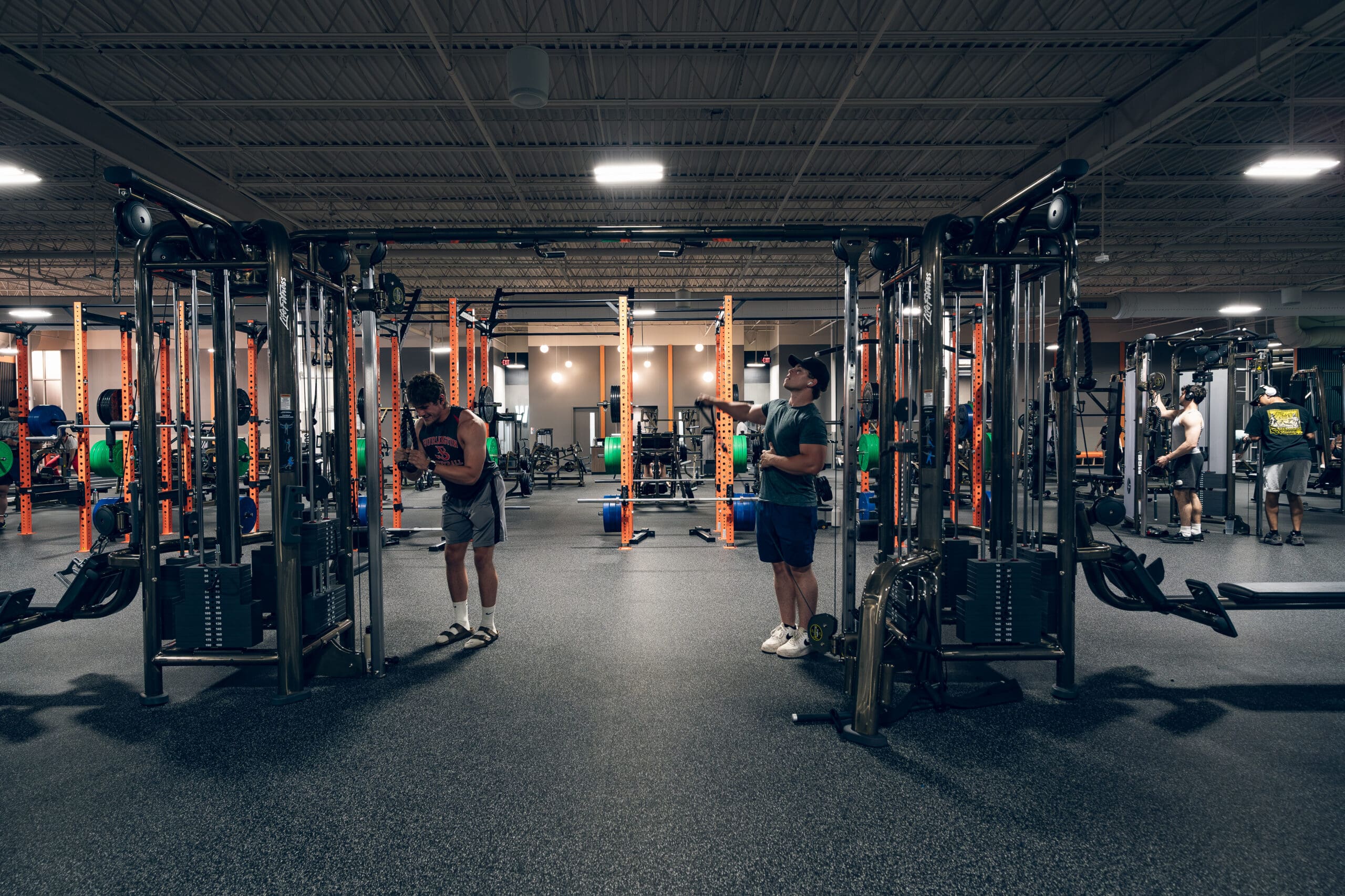 Best Fitness Woburn new location gym floor with cable machines, power racks, and members' training.